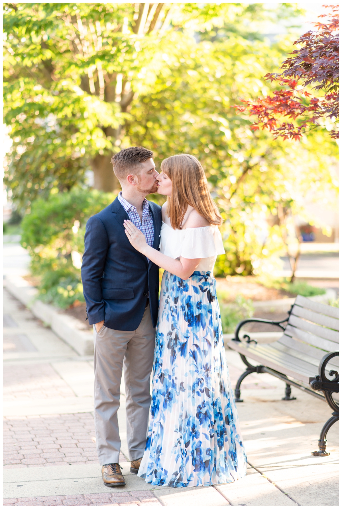 Engaged couple kissing downtown Doylestown during summer