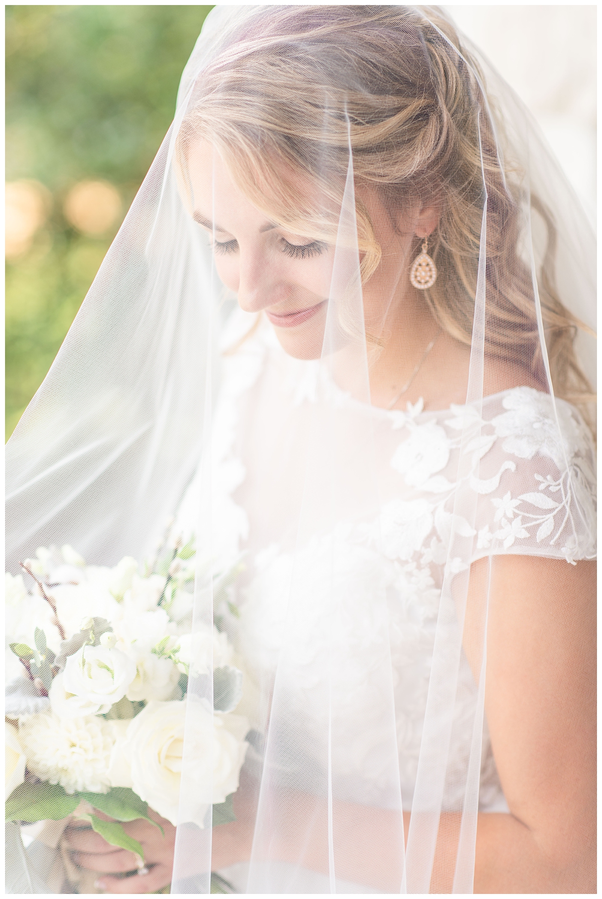 Bride wearing veil with blusher